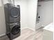 Bathroom with a stacked washer and dryer and a bathtub with a shower featuring white tile walls at 3655 Brisbane Dr, Marietta, GA 30062