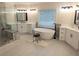 Bright bathroom features a freestanding tub, glass shower, and double sink vanity at 3655 Brisbane Dr, Marietta, GA 30062