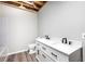 Modern bathroom featuring a double vanity, matte black faucets, and hardwood floors at 3655 Brisbane Dr, Marietta, GA 30062