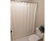 Bathroom with white cabinets and shower/tub featuring white shower curtain at 3655 Brisbane Dr, Marietta, GA 30062