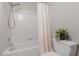 Clean bathroom with a tub and shower featuring white tile at 3655 Brisbane Dr, Marietta, GA 30062
