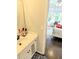 Bright bathroom vanity with white cabinets, mirror, and view of bedroom at 3655 Brisbane Dr, Marietta, GA 30062
