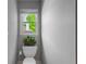 Small powder room features a toilet, small potted plant, and natural light at 3655 Brisbane Dr, Marietta, GA 30062