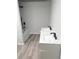 Modern bathroom features a double sink vanity, bathtub and shower with black fixtures, and wood-look floors at 3655 Brisbane Dr, Marietta, GA 30062