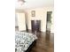 Bedroom featuring hard wood floors, large bed, and view of ensuite bath at 3655 Brisbane Dr, Marietta, GA 30062