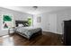Bedroom with dark wood floors and multiple windows overlooking the backyard at 3655 Brisbane Dr, Marietta, GA 30062