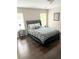 Comfortable bedroom features a plush bed, rich hardwood floors, and natural light from two windows at 3655 Brisbane Dr, Marietta, GA 30062
