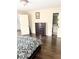 Bedroom with hardwood floors, large dresser, and doorways to bathroom and hall at 3655 Brisbane Dr, Marietta, GA 30062