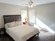 Bedroom features hardwood floors, ceiling fan, plush bed, and natural light from two windows at 3655 Brisbane Dr, Marietta, GA 30062