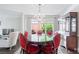 Formal dining room with a chandelier, large windows, and a table with red velvet chairs at 3655 Brisbane Dr, Marietta, GA 30062