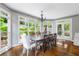 Bright dining room with large windows overlooking the garden and traditional wooden table and chairs at 3655 Brisbane Dr, Marietta, GA 30062