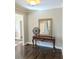 Elegant entryway featuring dark hardwood floors and an ornate table with a decorative mirror at 3655 Brisbane Dr, Marietta, GA 30062