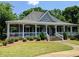 Charming home with a large porch, landscaped yard, and a welcoming entrance at 3655 Brisbane Dr, Marietta, GA 30062