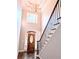 Bright foyer with a decorative chandelier, hardwood floors, and a staircase with a black railing at 3655 Brisbane Dr, Marietta, GA 30062