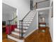 Elegant foyer featuring hardwood floors, staircase with iron railing, and view into the living area at 3655 Brisbane Dr, Marietta, GA 30062