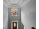 View of the foyer with a wooden front door, chandelier, and tall ceilings, creating an inviting entrance at 3655 Brisbane Dr, Marietta, GA 30062