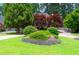 Well-manicured front yard with lush landscaping, including mature trees and colorful bushes at 3655 Brisbane Dr, Marietta, GA 30062