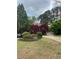 Charming home with a well-manicured lawn, mature trees, and a circular driveway for ample parking at 3655 Brisbane Dr, Marietta, GA 30062