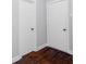 Hallway view featuring hardwood floors and two white doors, enhancing a clean and simple design at 3655 Brisbane Dr, Marietta, GA 30062