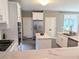A modern kitchen boasts stainless steel appliances, a large island, and white cabinetry at 3655 Brisbane Dr, Marietta, GA 30062
