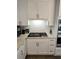 Modern kitchen with white cabinets, granite countertops, tile backsplash, and stainless steel appliances at 3655 Brisbane Dr, Marietta, GA 30062