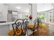 Breakfast bar with wrought iron stools separates the kitchen from the dining area with garden view at 3655 Brisbane Dr, Marietta, GA 30062