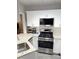 Modern kitchen with stainless steel appliances, granite countertops, and white cabinetry at 3655 Brisbane Dr, Marietta, GA 30062