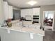 Bright kitchen with white cabinets, marble countertops, stainless steel appliances, and a breakfast bar at 3655 Brisbane Dr, Marietta, GA 30062