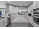 Modern kitchen with white cabinets, marble countertops, stainless steel appliances, and a center island at 3655 Brisbane Dr, Marietta, GA 30062