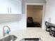 Cozy kitchenette features granite counters, white cabinets and stainless sink at 3655 Brisbane Dr, Marietta, GA 30062