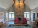 Spacious living room with stone fireplace, vaulted ceilings, and french doors to the outside at 3655 Brisbane Dr, Marietta, GA 30062