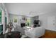 Bright living room with hardwood floors, neutral furniture, fireplace, and large windows with garden view at 3655 Brisbane Dr, Marietta, GA 30062