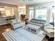 Open-concept living room with modern furnishings, hardwood floors, and views into the kitchen and dining area at 3655 Brisbane Dr, Marietta, GA 30062