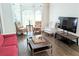 Bright seating area with hardwood floors, a large TV, and lots of natural light at 3655 Brisbane Dr, Marietta, GA 30062