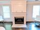 Living room featuring a white fireplace with a decorative mantel and bright windows at 3655 Brisbane Dr, Marietta, GA 30062