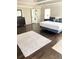 Bright main bedroom with hardwood floors, plush rug and ensuite bathroom at 3655 Brisbane Dr, Marietta, GA 30062