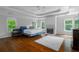 Spacious main bedroom with trey ceiling, fireplace, hardwood floors, and natural light from multiple windows at 3655 Brisbane Dr, Marietta, GA 30062