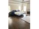 The spacious main bedroom features hardwood floors, a fireplace, and natural light at 3655 Brisbane Dr, Marietta, GA 30062