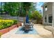 Outdoor patio area with a dining table set surrounded by a landscaped backyard at 3655 Brisbane Dr, Marietta, GA 30062