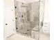 Modern glass shower features marbled walls, black fixtures, and a built-in bench at 3655 Brisbane Dr, Marietta, GA 30062
