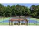 Community tennis court with a pergola and benches and landscaping in the background at 3655 Brisbane Dr, Marietta, GA 30062