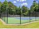 View of the community tennis courts with a fence and landscaping, perfect for recreation at 3655 Brisbane Dr, Marietta, GA 30062