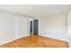 Bedroom with hardwood floors, closet with folding doors, and access to additional rooms at 4433 Canary Ct, Lithia Springs, GA 30122