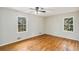 Spacious bedroom featuring hardwood floors and abundant natural light from two large windows at 4433 Canary Ct, Lithia Springs, GA 30122