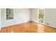 Bright bedroom featuring hardwood floors and two windows with natural light at 4433 Canary Ct, Lithia Springs, GA 30122