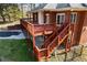 Multi-level deck and stairs are built with wood and look out over the yard at 5595 Rolling Acres Ln, Cumming, GA 30028