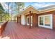 Expansive back deck offers outdoor living space with a brick house exterior at 5595 Rolling Acres Ln, Cumming, GA 30028