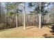 The large backyard with mature trees offers an abundance of space and natural privacy at 5595 Rolling Acres Ln, Cumming, GA 30028