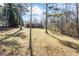 Backyard with a view of house, trees, and large grassy area at 5595 Rolling Acres Ln, Cumming, GA 30028