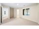 Spacious finished basement with plush carpet and large window to outside at 5595 Rolling Acres Ln, Cumming, GA 30028